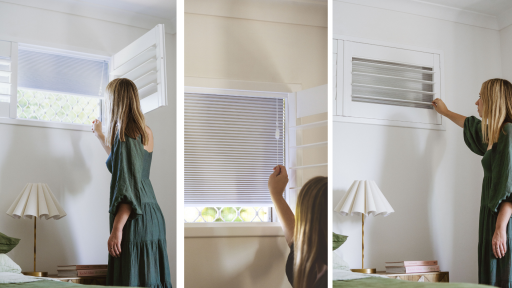 A lady in a green dress operating Norman's Blockout Shutter which is a Honeycomb or Cell Blind behind a Shutter. This is Norman's top pick for the best window covering